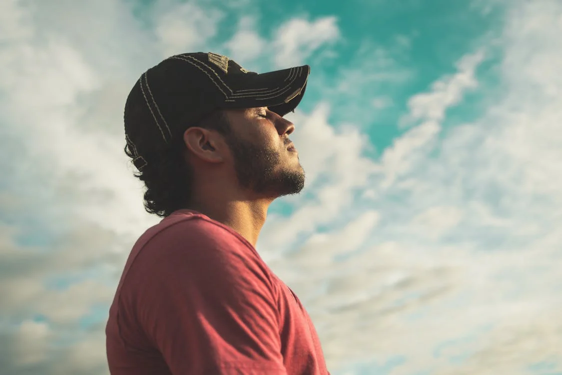 man wearing cap basking in the sun