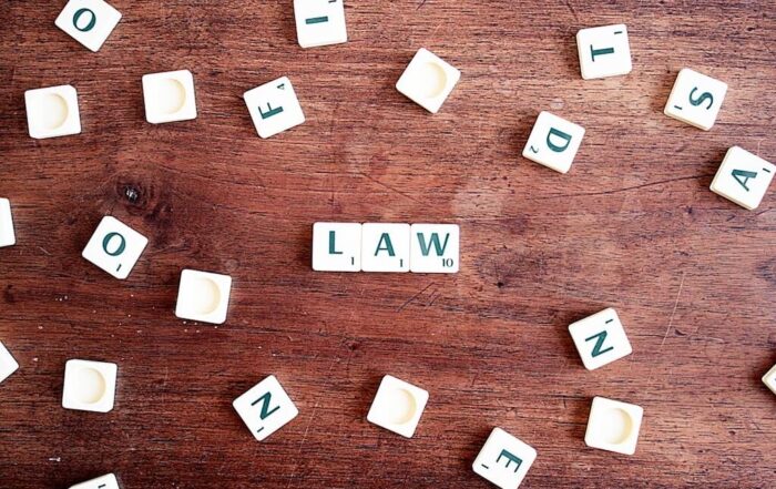 Scrabble tiles spelling out "law"