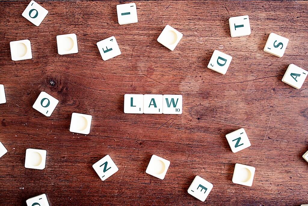 Scrabble tiles spelling out "law"